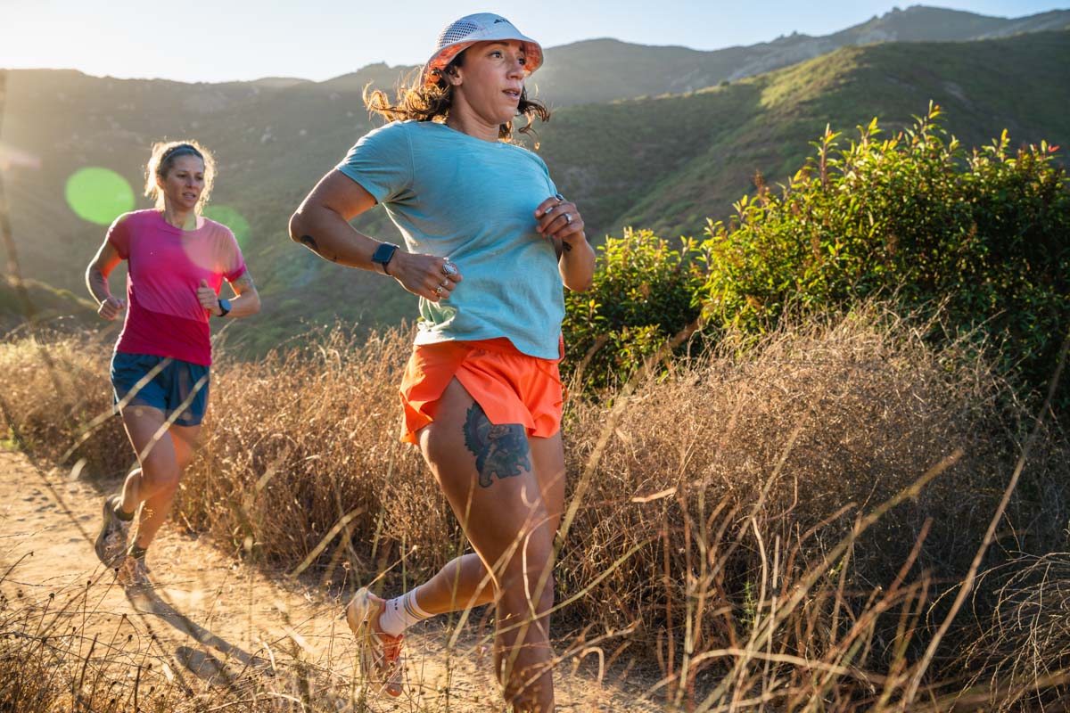 Best Running Hat - women running on trail in bucket hat